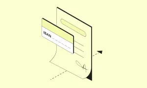 Un documento con un IBAN e una carta. L'IBAN ha 27 caratteri, essenziali per le transazioni bancarie.