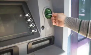 Mano inserisce una carta in un bancomat. Sospetto che il prelievo bancomat non effettuato da me.