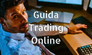 Uomo concentrato davanti a schermi, testo "Guida Trading Online".