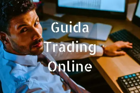 Uomo concentrato davanti a schermi, testo "Guida Trading Online".