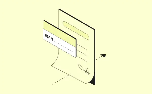 Un documento con un IBAN e una carta. L'IBAN ha 27 caratteri, essenziali per le transazioni bancarie.