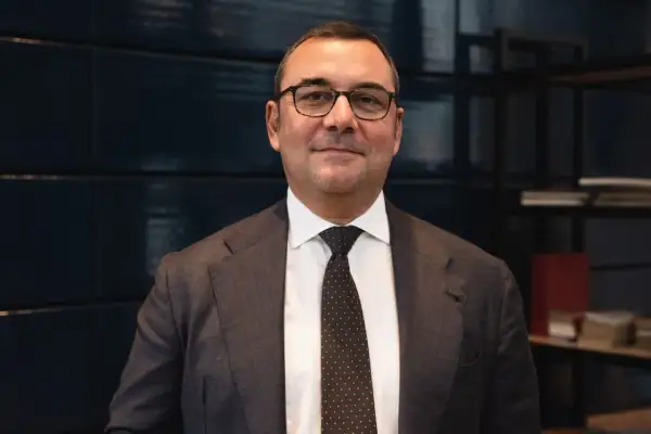 Uomo in giacca e cravatta, con occhiali, che parla di investimenti SRI, definizione e opportunità.
